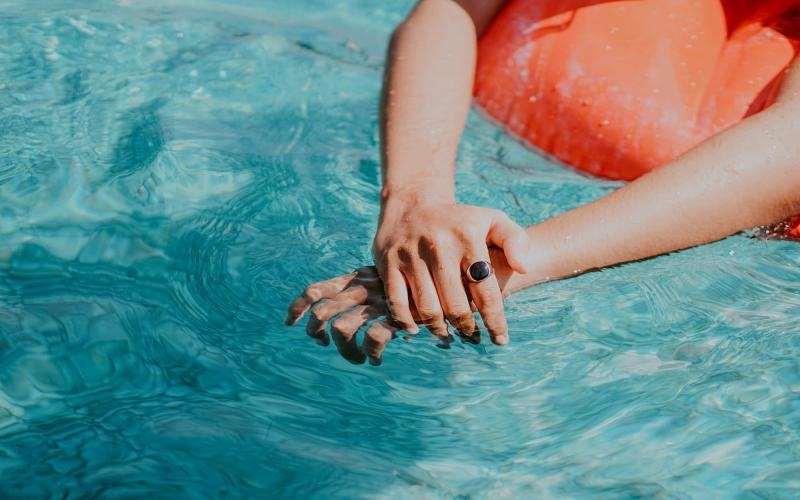 woman relaxes on a floatie in swimming pool